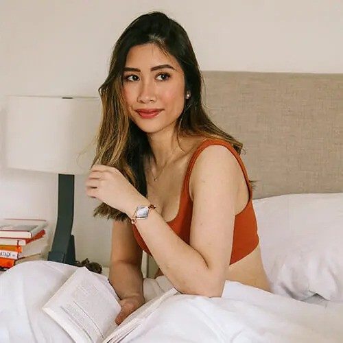 Kim, an IvyHealth member, wearing the Ivy bracelet while reading in bed